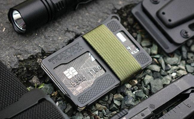 Armored Summit Laying on Rocks next to a Black Multi-Tool, Flashlight, Black Kydex Sheath, and Black Designer Cinch Belt